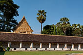 Vientiane, Laos - Pha That Luang, the elegant structure, Wat That Luang Neua, with a very ornate front faade fronted by two tall standing Buddha statues. 